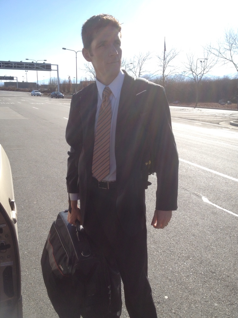 A person with formal suit with a striped tie